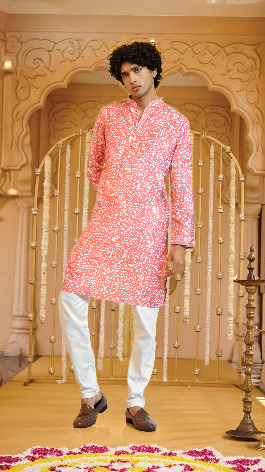 Man wearing a pink embroidered kurta pajama, perfect for Rath Yatra and festive celebrations.